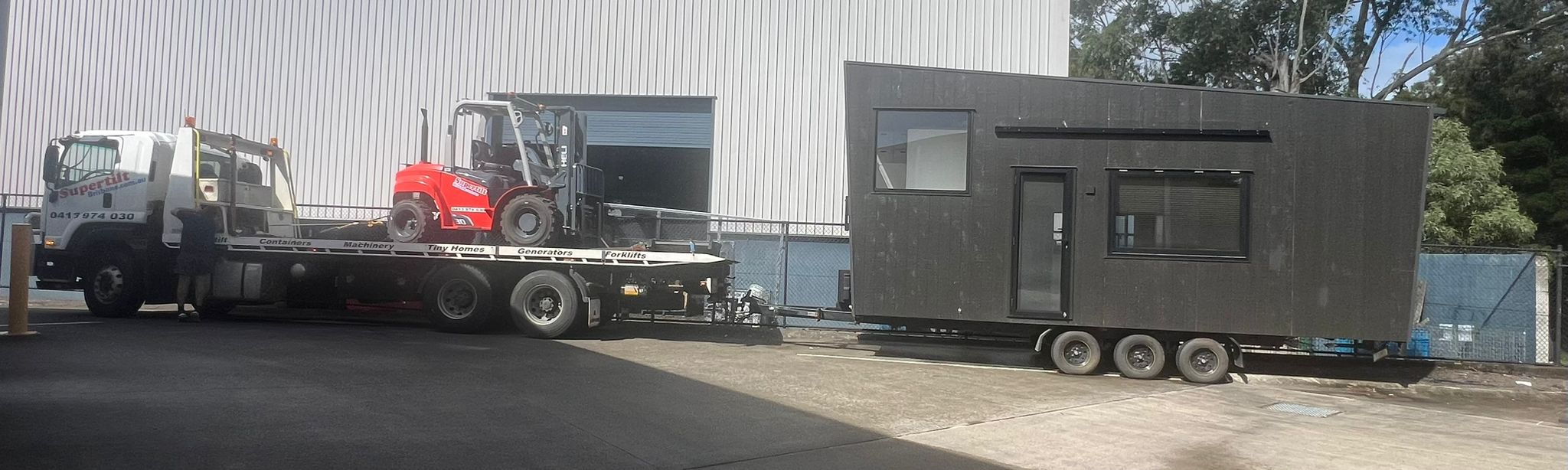 Tiny home transport Brisbane — cabin at warehouse