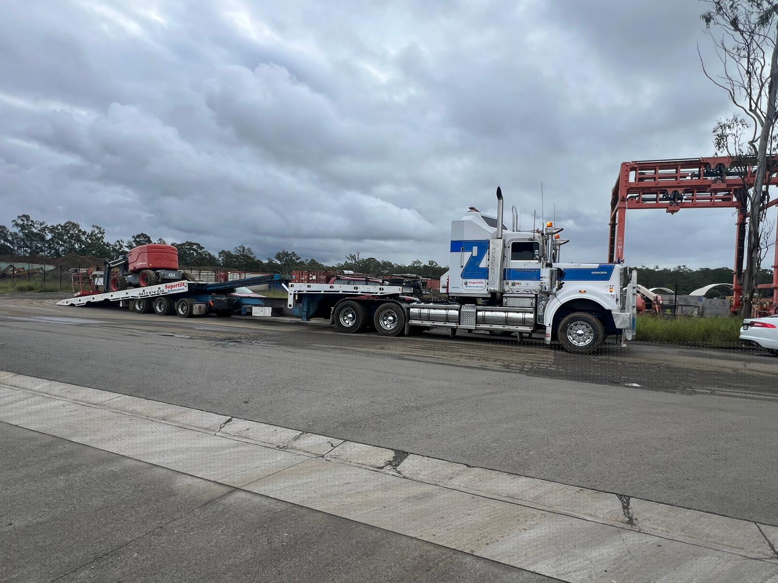 Heavy equipment transport Brisbane — boom lift