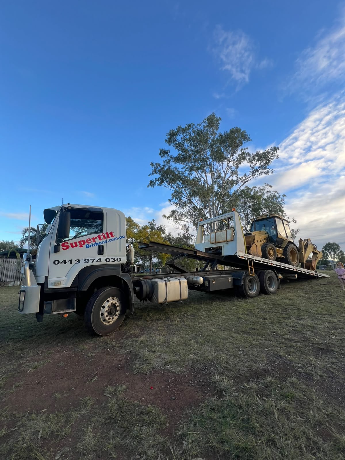 Machinery transport Brisbane — Cat backhoe loader